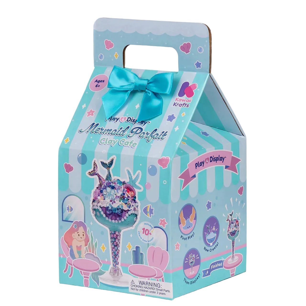A toy packaging box for the Anya & David's Mermaid Perfume Clay Cake, featuring a light blue and white striped design with a large blue bow, mermaid illustrations, and product details on the front.